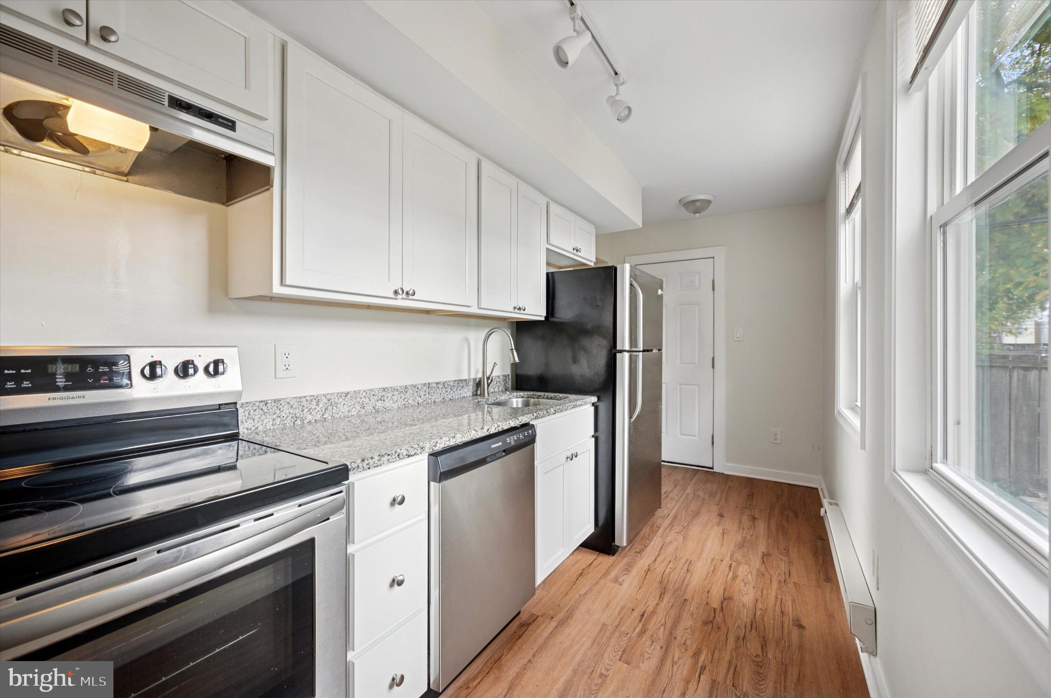 237 Roxborough Avenue, Unit 2 Philadelphia, PA 19128 - Photo 15 of 19 a kitchen with a stove a sink and a refrigerator