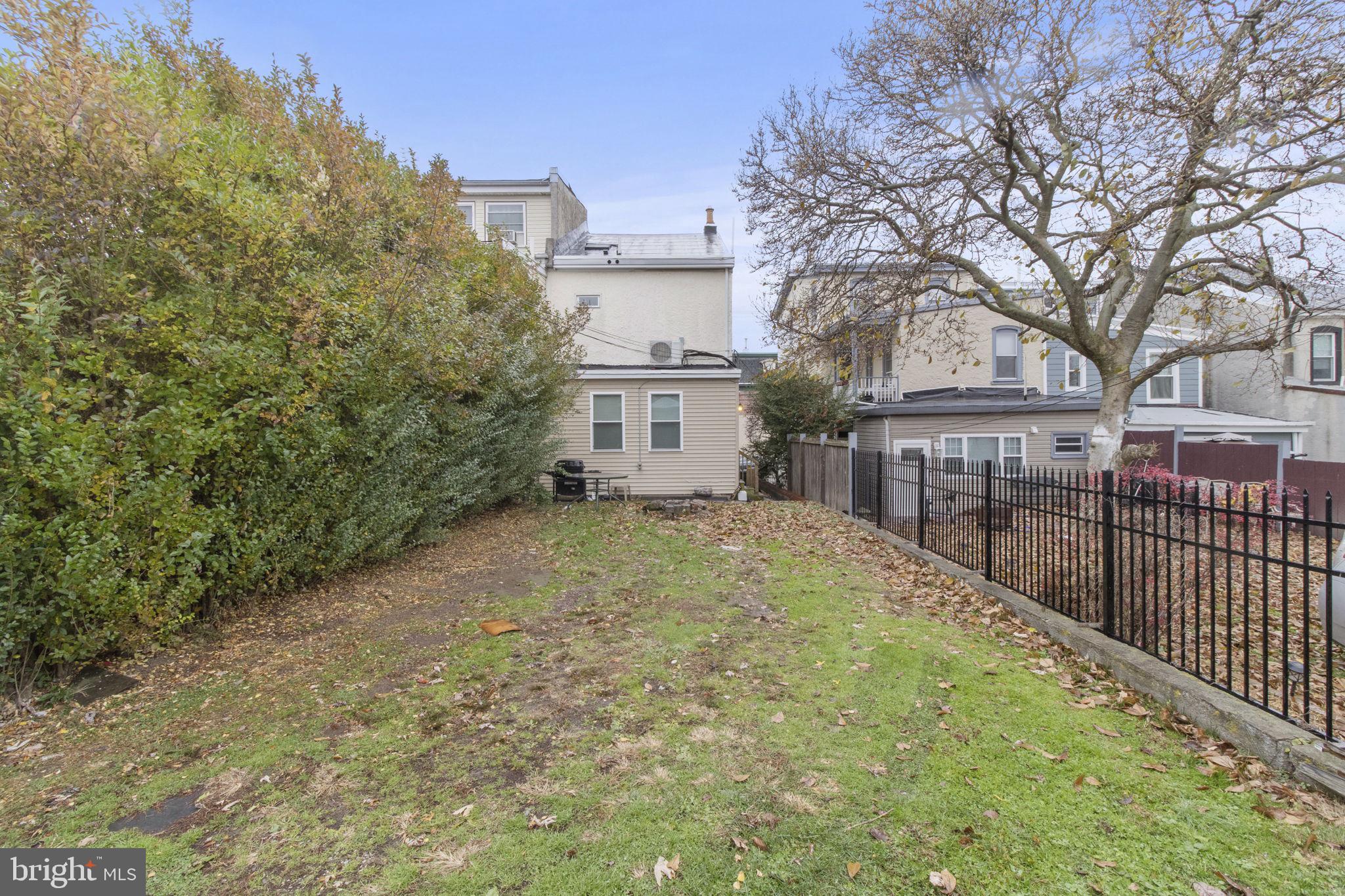 237 Roxborough Avenue, Unit 2 Philadelphia, PA 19128 - Photo 17 of 19 a view of a backyard with large trees