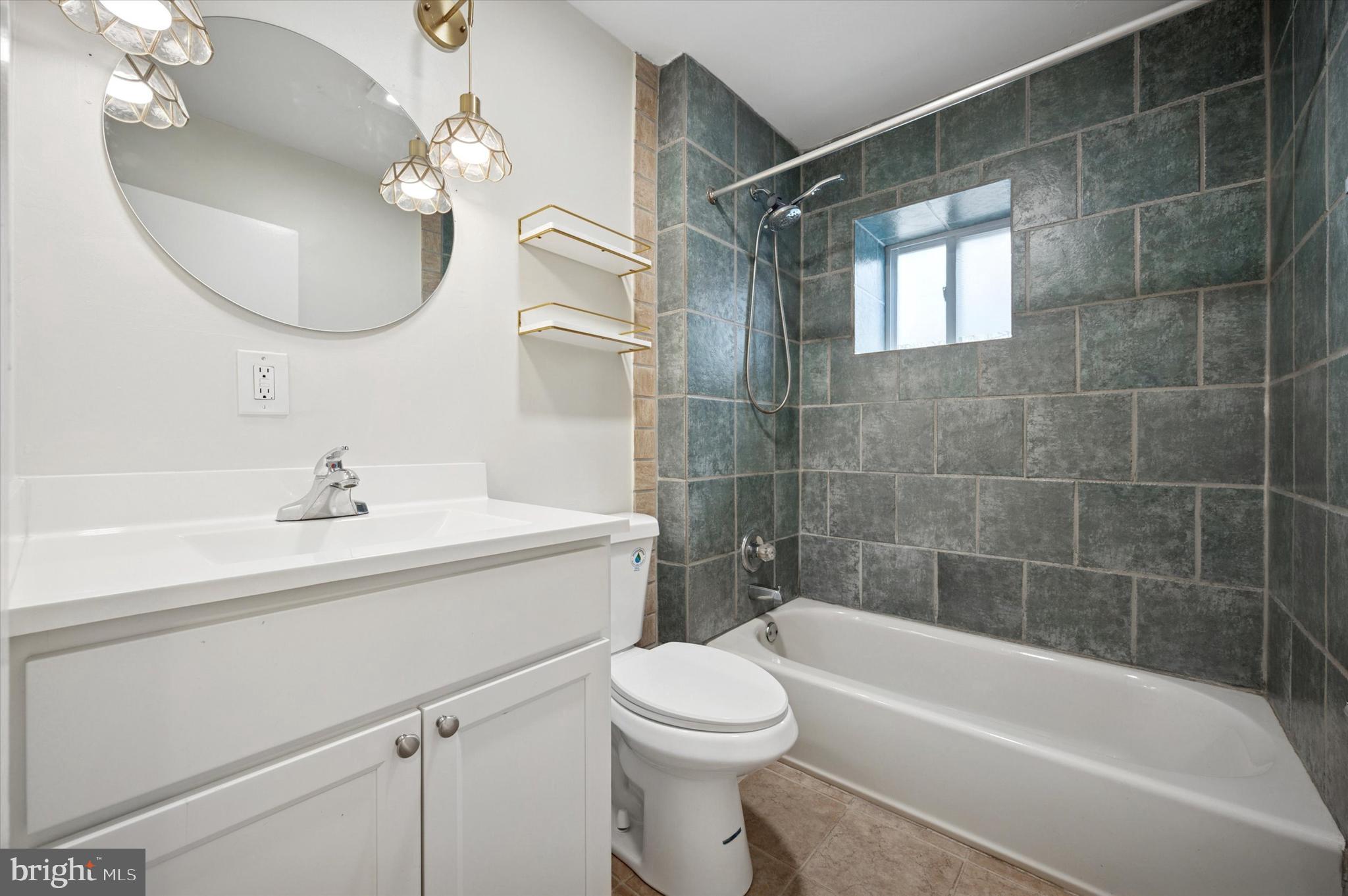 237 Roxborough Avenue, Unit 2 Philadelphia, PA 19128 - Photo 5 of 19 a bathroom with a sink a toilet and shower