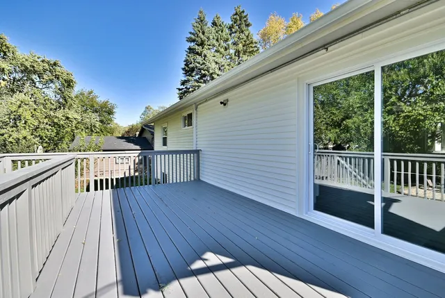 a view of balcony with wooden floor and fence