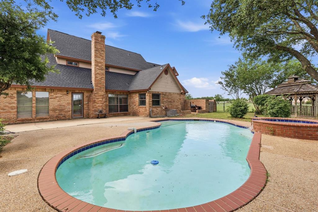 211 Bayne Road Haslet, TX 76052 - Photo 3 of 29 a swimming pool with outdoor seating and yard