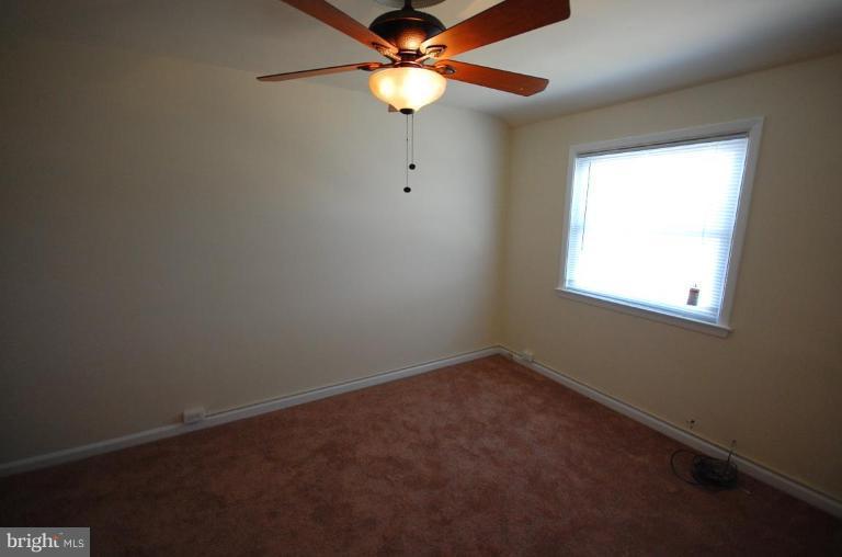 4461 Fenor Road Halethorpe, MD 21227 - Photo 8 of 9 an empty room with a window and a fan