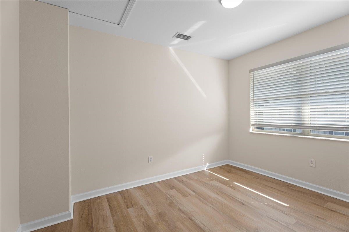 4420 Carter Road, Unit 33 St. Augustine, FL 32086 - Photo 17 of 20 a view of a room with wooden floor and windows