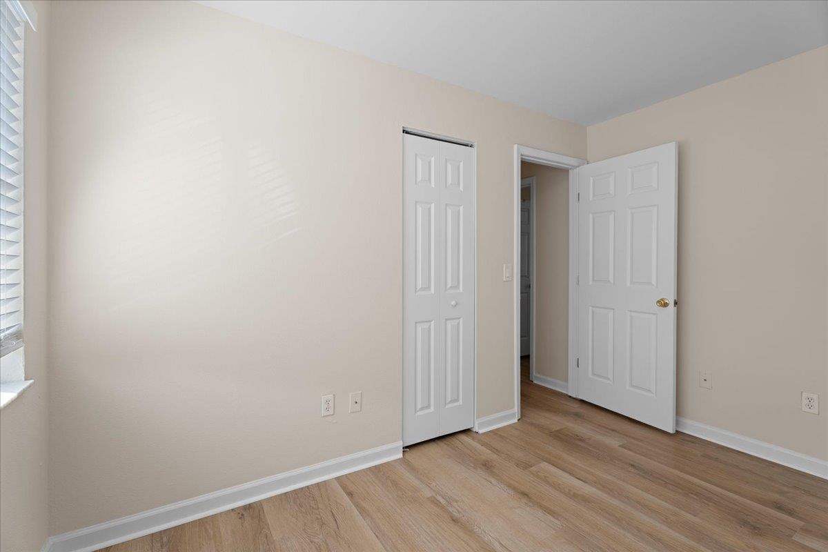 4420 Carter Road, Unit 33 St. Augustine, FL 32086 - Photo 18 of 20 a view of an empty room with wooden floor and closet
