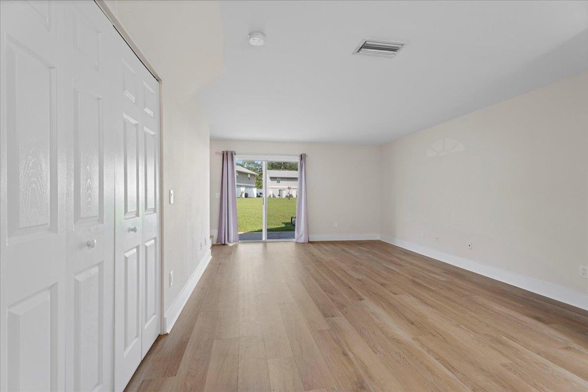 4420 Carter Road, Unit 33 St. Augustine, FL 32086 - Photo 6 of 20 a view of an empty room with a window and wooden floor