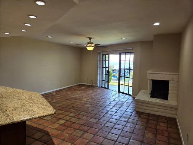 a view of a livingroom with a fireplace and window