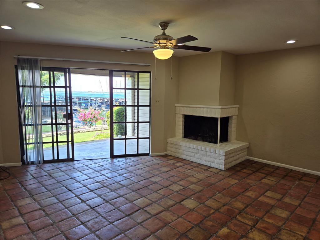 428 Yacht Club Drive, Unit B Rockwall, TX 75032 - Photo 3 of 11 a view of a livingroom with a fireplace a chandelier and wooden floor