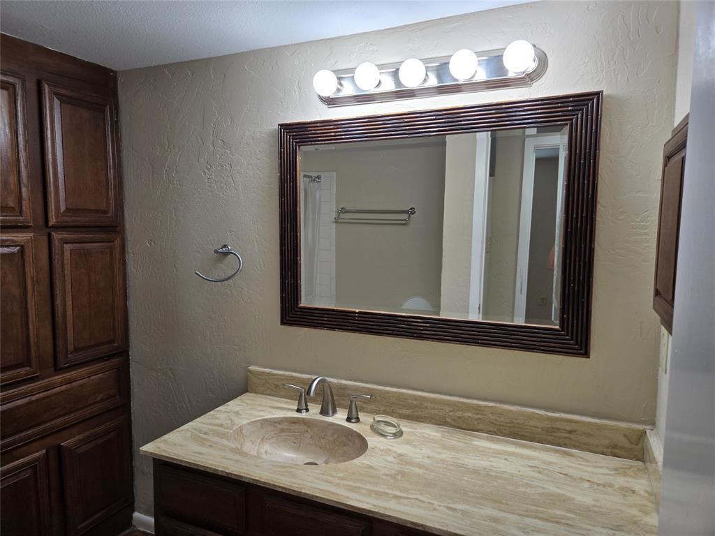 428 Yacht Club Drive, Unit B Rockwall, TX 75032 - Photo 7 of 11 a bathroom with a sink and a mirror