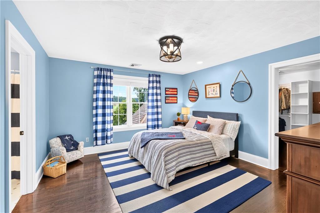 486 Settler Road Ligonier, PA 15658 - Photo 31 of 49 In addition to the Primary Suite, we have two spacious Bedrooms, with terrific Walk-In Closets and en-suite Bathrooms. Hardwood, new lighting.