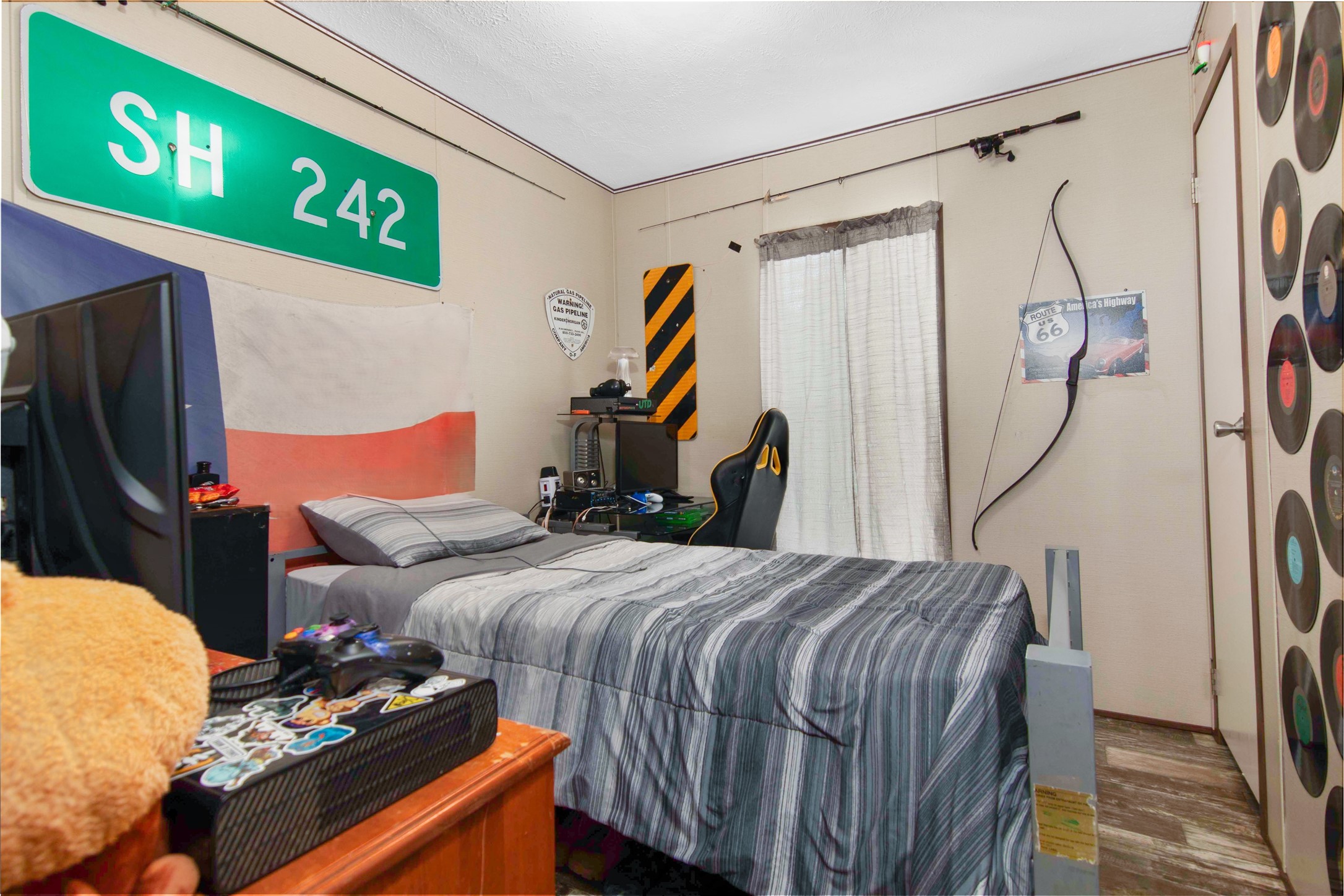 18093 Pickering Road Conroe, TX 77302 - Photo 23 of 29 a bedroom with a bed and a painting on the wall