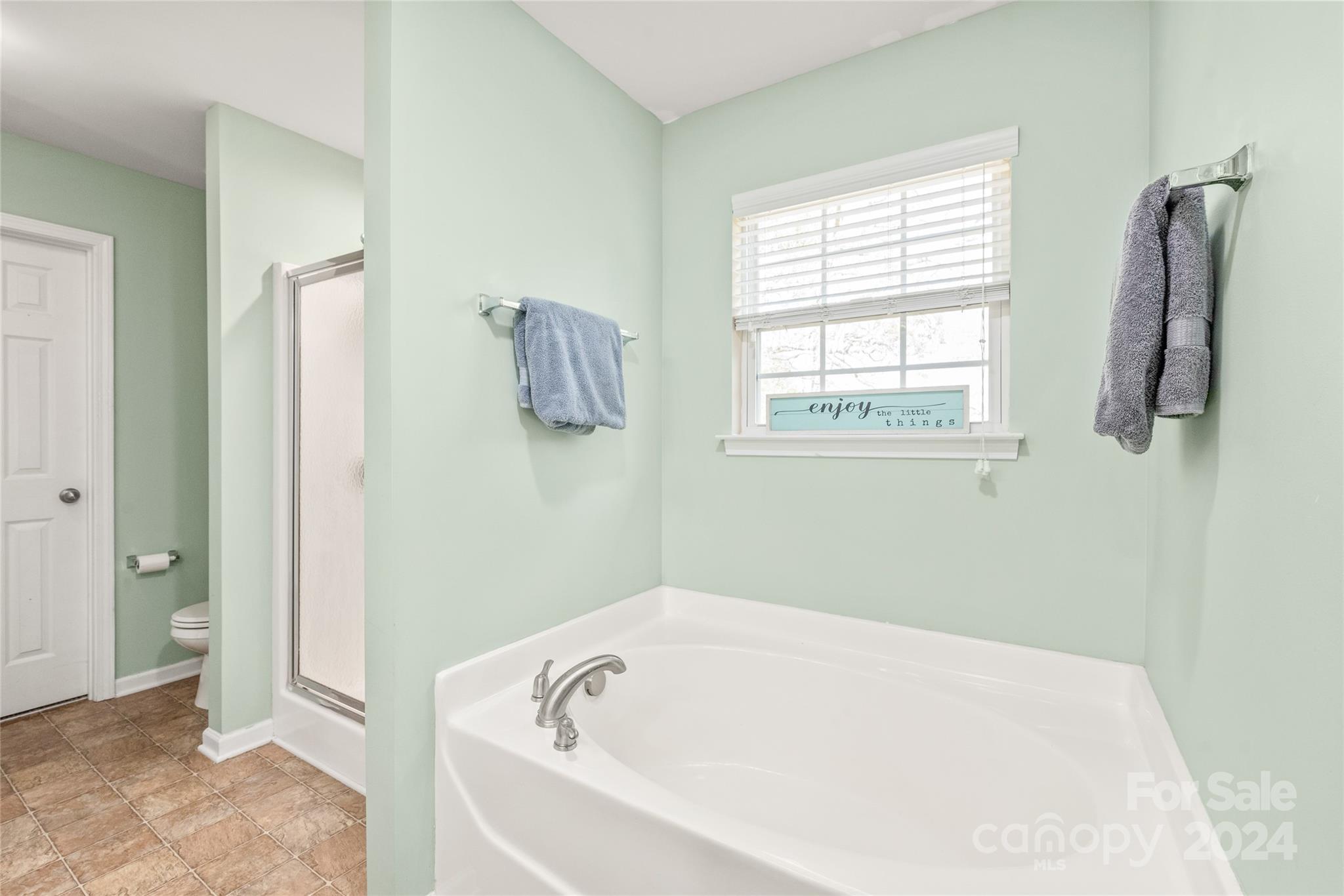 11616 Mud Drive Midland, NC 28107 - Photo 17 of 29 a white bath tub sitting in a bathroom next to a window