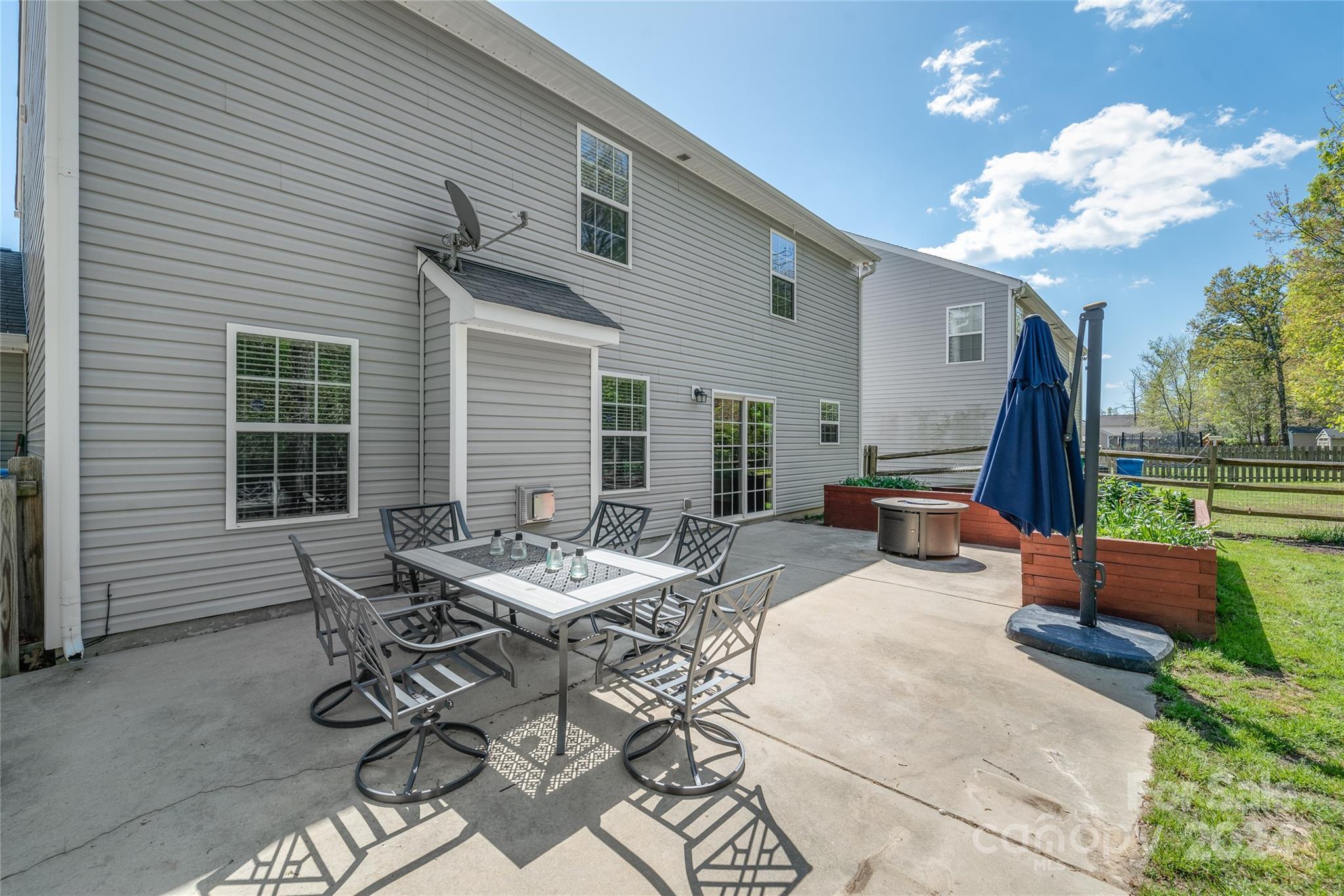 11616 Mud Drive Midland, NC 28107 - Photo 24 of 29 a view of a patio with table and chairs and a barbeque