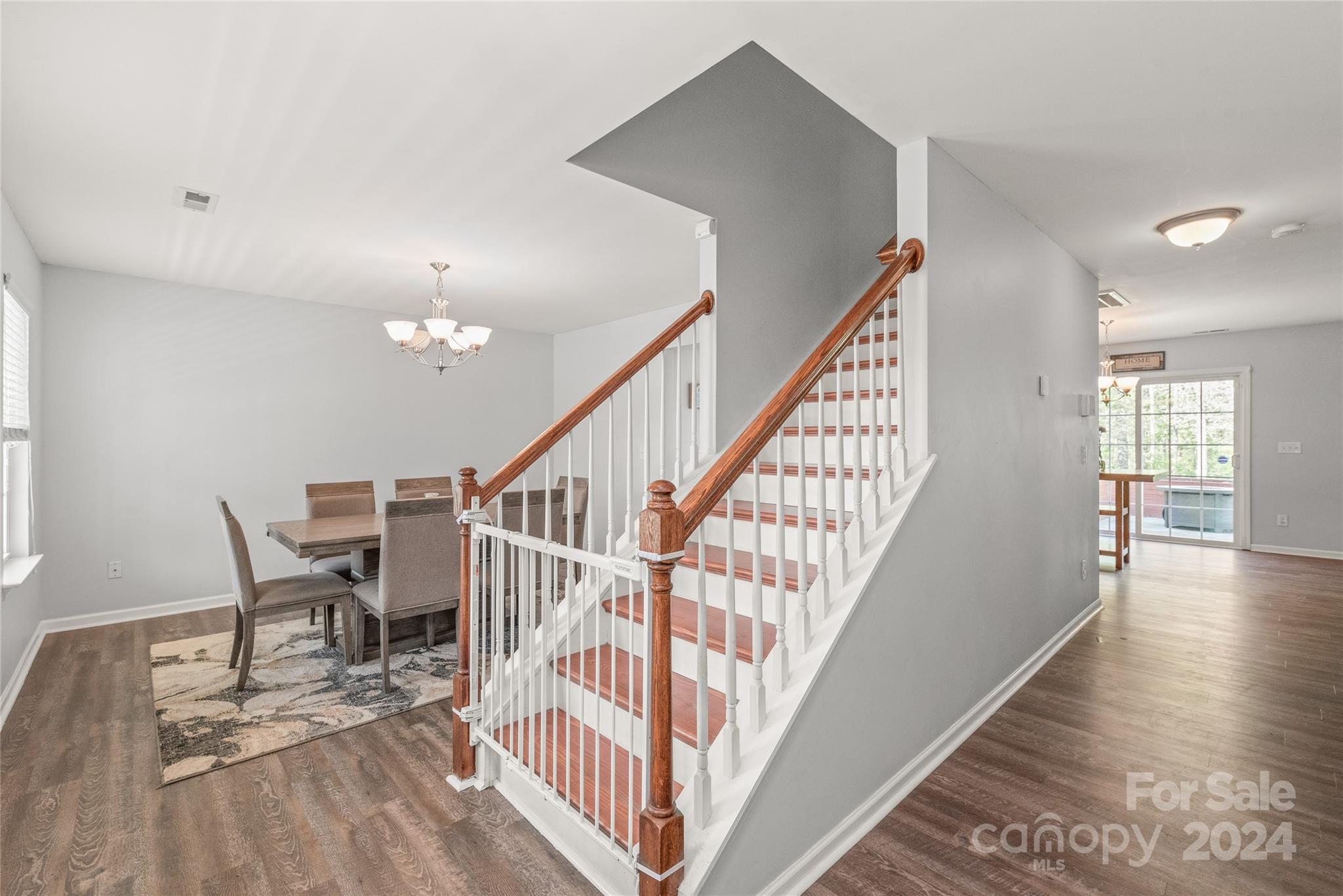 11616 Mud Drive Midland, NC 28107 - Photo 3 of 29 a view of staircase and dining room with wooden floor and a chandelier