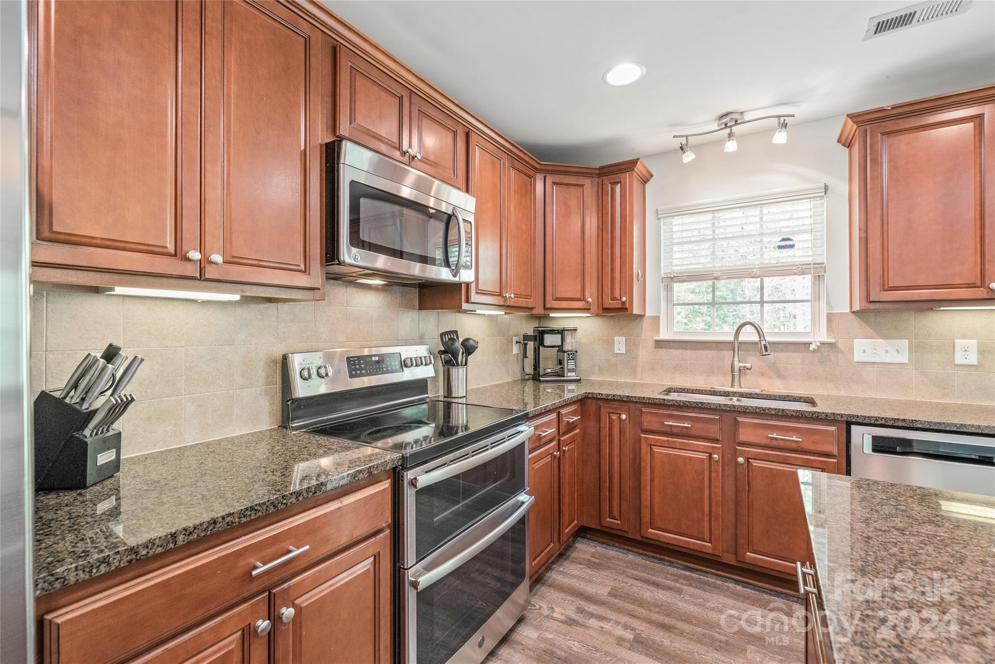 11616 Mud Drive Midland, NC 28107 - Photo 6 of 29 a kitchen with stainless steel appliances granite countertop wooden cabinets a sink and dishwasher
