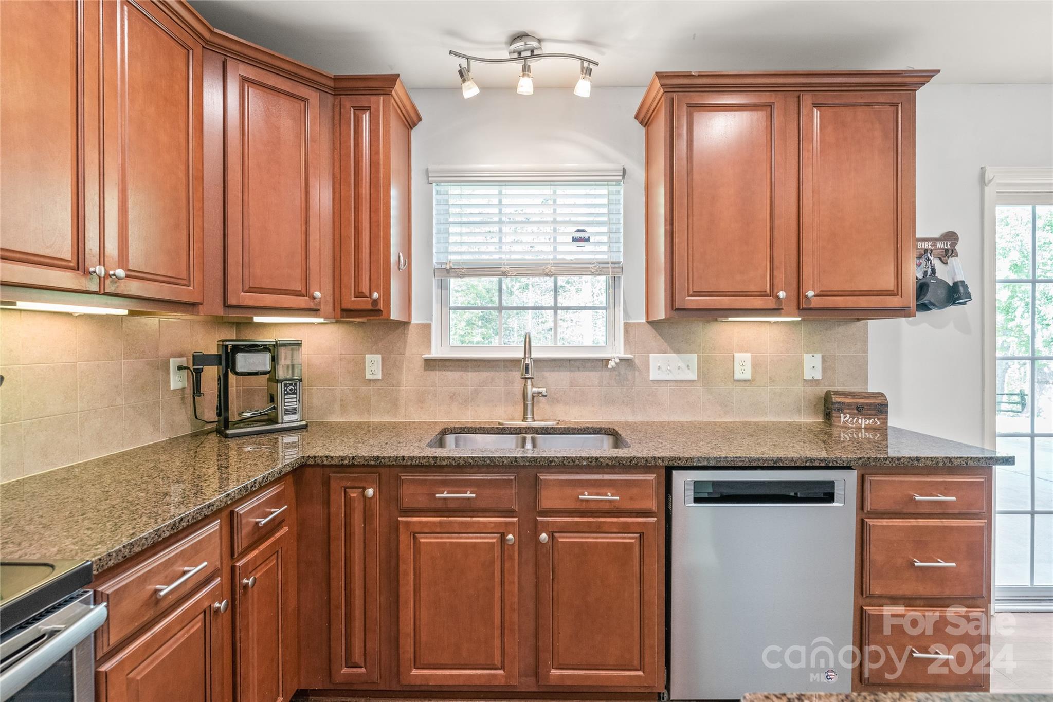 11616 Mud Drive Midland, NC 28107 - Photo 7 of 29 a kitchen with granite countertop a sink stainless steel appliances white cabinets and a window