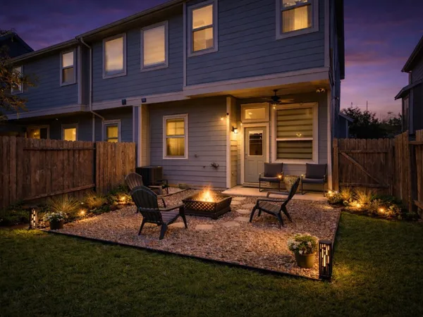a view of a house with backyard sitting area and garden