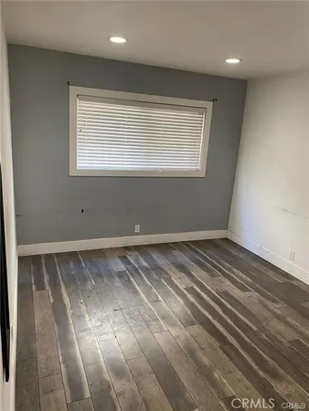 a view of a room with wooden floor and window