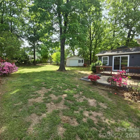 a view of a house with a yard and garage