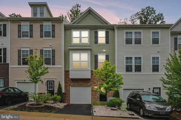 a large kitchen with stainless steel appliances kitchen island a large counter space a sink and a wooden floor
