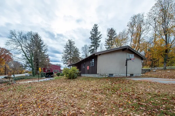 a house that has a tree in front of it