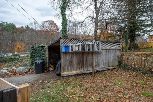 a view of a small house in the forest
