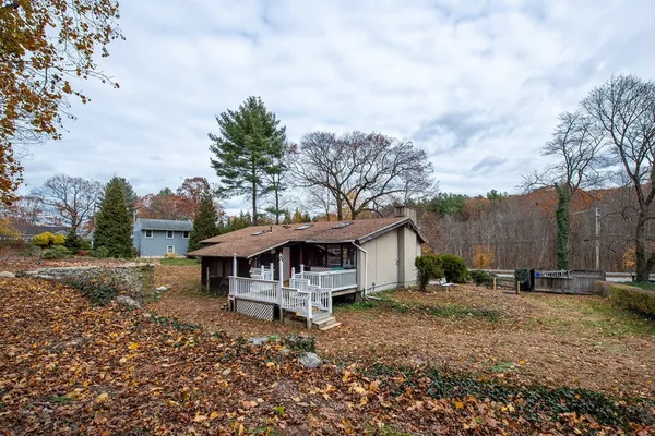 a view of a house with a yard and sitting area