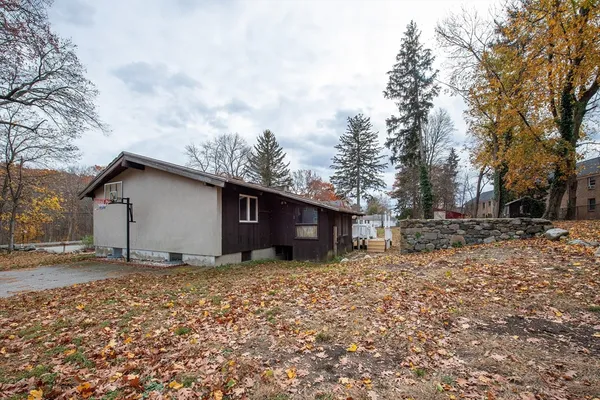 a backyard of a house with large trees