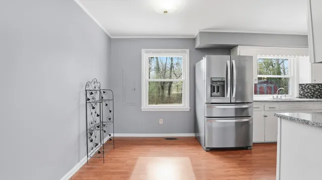 a kitchen with stainless steel appliances a refrigerator and a window
