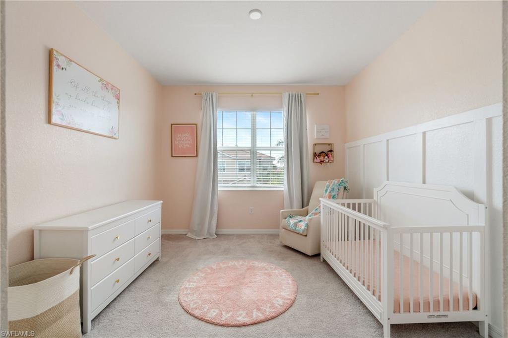 2767 Blossom Way Naples, FL 34120 - Photo 19 of 38 a bedroom with furniture and a window