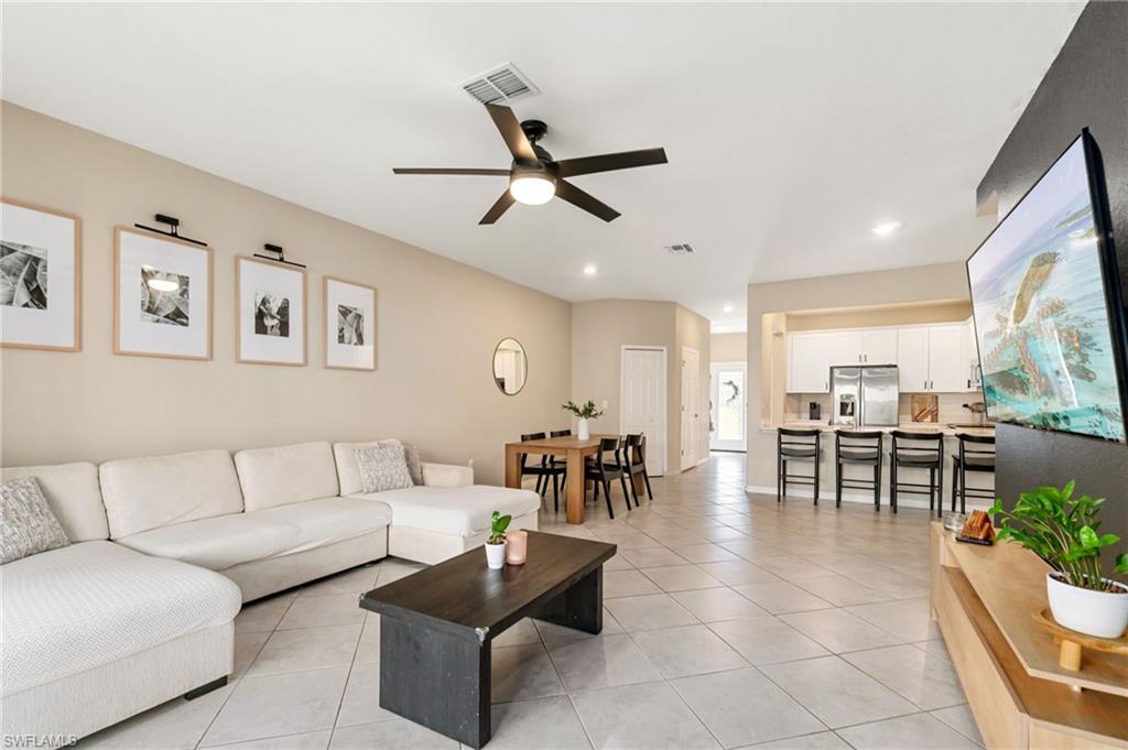 2767 Blossom Way Naples, FL 34120 - Photo 2 of 38 a living room with furniture and a large window