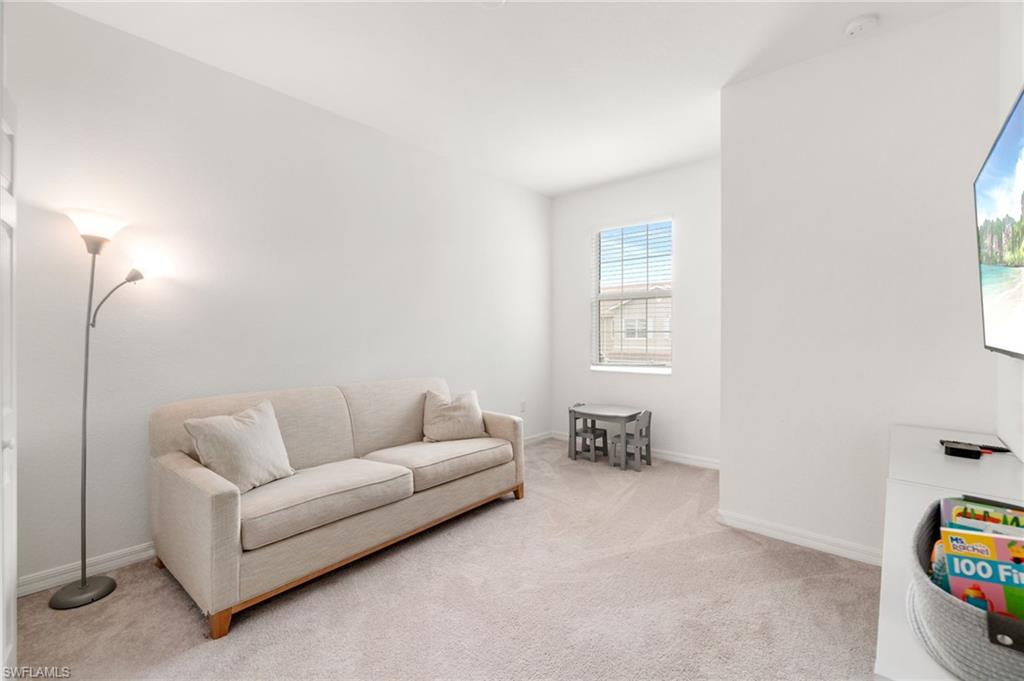2767 Blossom Way Naples, FL 34120 - Photo 21 of 38 a living room with furniture and a window
