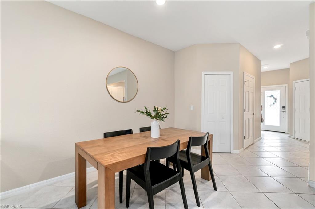 2767 Blossom Way Naples, FL 34120 - Photo 5 of 38 a dining room with furniture and a potted plant