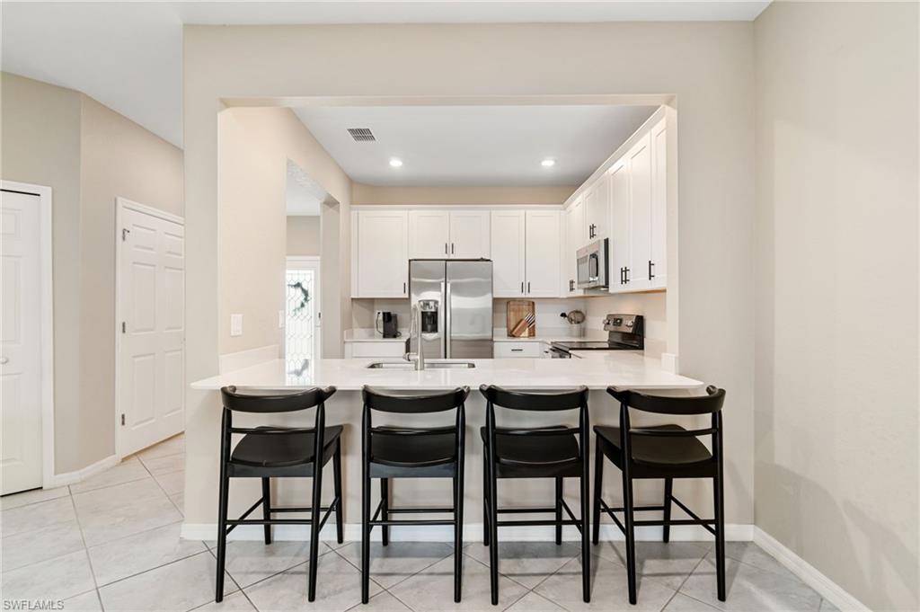 2767 Blossom Way Naples, FL 34120 - Photo 9 of 38 a view of a dining room with furniture