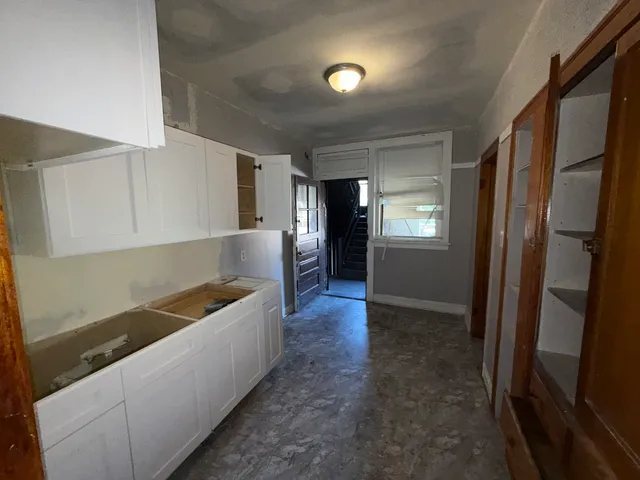 a kitchen with stainless steel appliances granite countertop a refrigerator and a stove