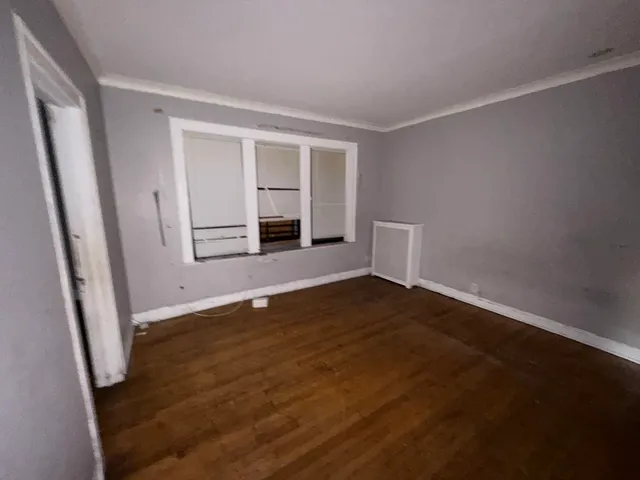 wooden floor in an empty room with a fireplace