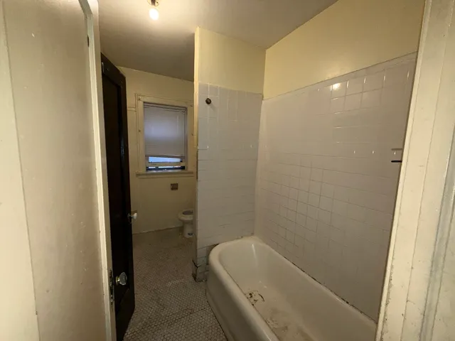 a bathroom with a tub and shower