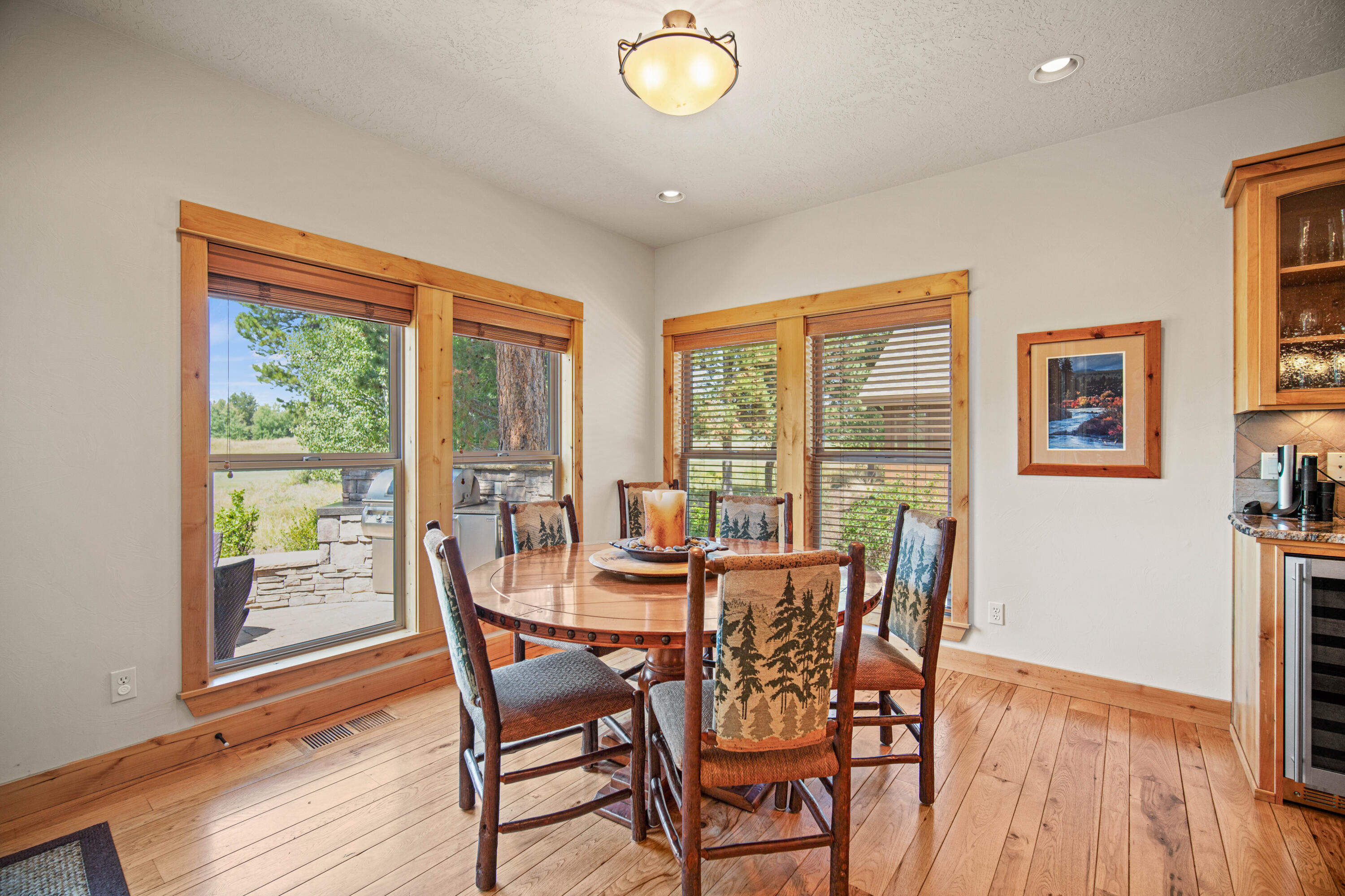 56689 Dancing Rock Loop Bend, OR 97707 - Photo 12 of 51 a dining room with furniture a chandelier and wooden floor