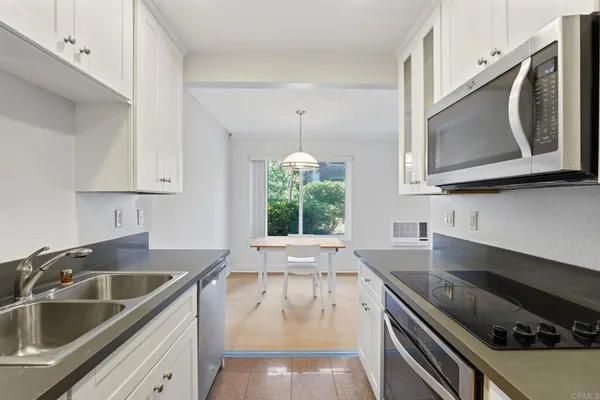 a kitchen with a sink stove top oven and cabinets
