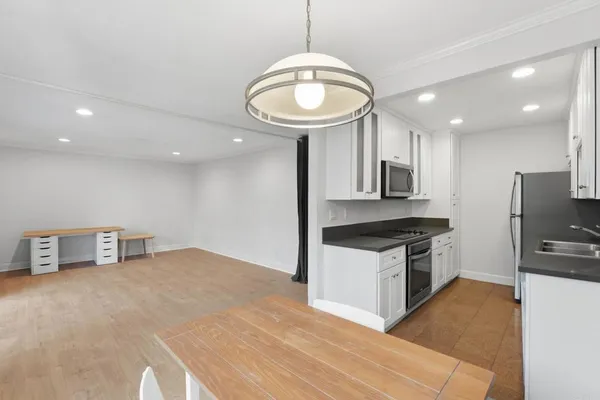 a kitchen with stainless steel appliances granite countertop a sink a stove and a refrigerator