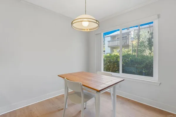 a view of a room that has a window and wooden floor