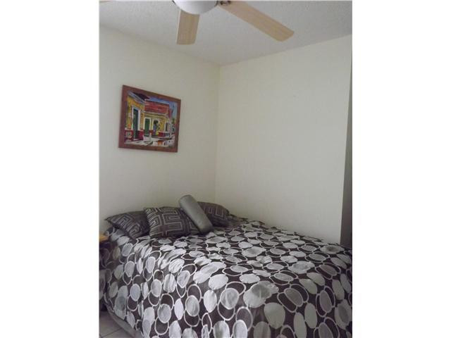 8410 Southwest 157th Court Miami, FL 33193 - Photo 11 of 15 a bedroom with a bed and a cabinets