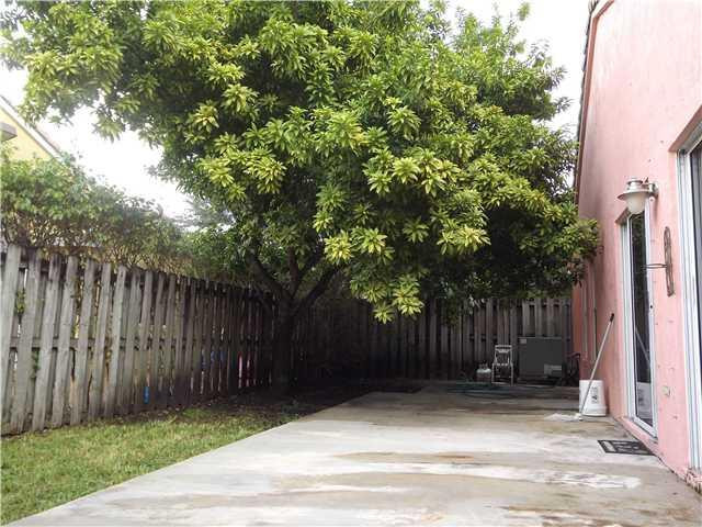 8410 Southwest 157th Court Miami, FL 33193 - Photo 13 of 15 a view of backyard with wooden fence and trees