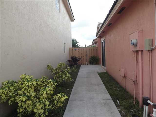 8410 Southwest 157th Court Miami, FL 33193 - Photo 2 of 15 a pathway of a house with flower plants