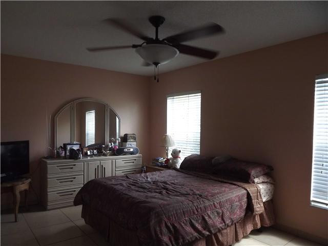 8410 Southwest 157th Court Miami, FL 33193 - Photo 7 of 15 a bedroom with a bed and a chandelier