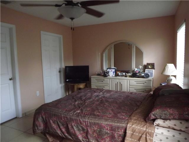8410 Southwest 157th Court Miami, FL 33193 - Photo 8 of 15 a living room with a bed furniture and a potted plant