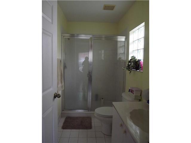8410 Southwest 157th Court Miami, FL 33193 - Photo 9 of 15 a bathroom with a granite countertop bathtub shower sink mirror and toilet