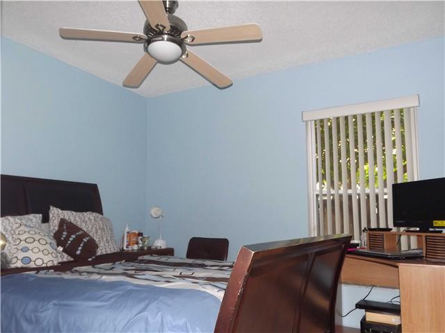8410 Southwest 157th Court Miami, FL 33193 - Photo 10 of 15 a bedroom with a bed and a flat screen tv