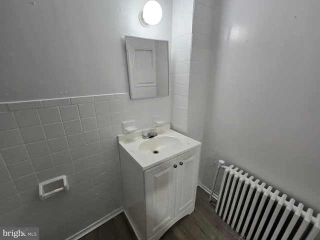 a bathroom with a sink toilet and mirror
