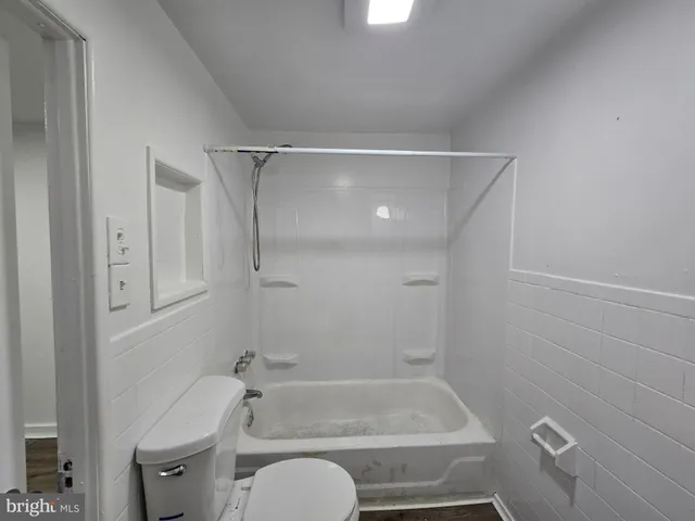 a bathroom with a shower and a toilet