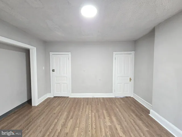 a view of room with wooden floor